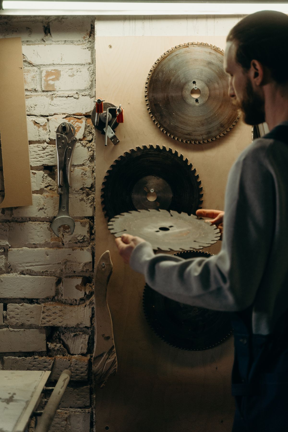 Craftsperson selecting tools in a workshop
